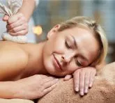 Woman enjoying a relaxing herbal massage.